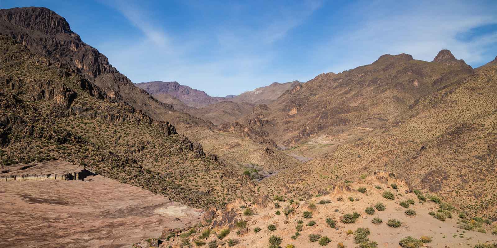 Scenic mountain range of Jebel Sahro looking down to valley road