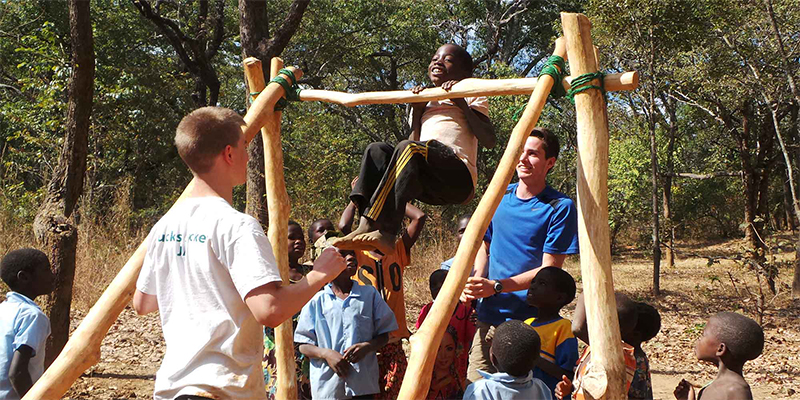 Zambian school children trying out climbing frame