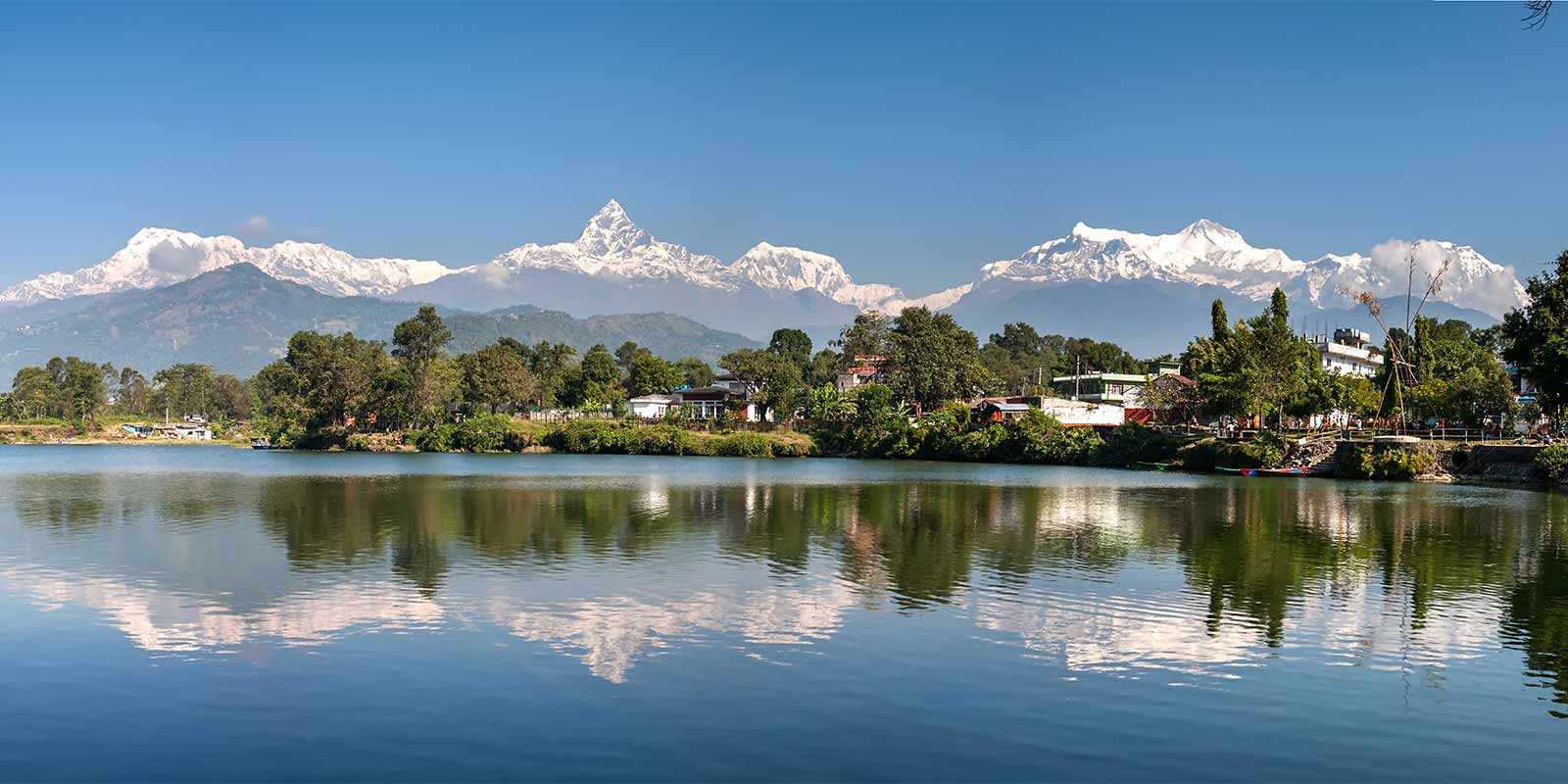 Phewa Lake with snow-capped Himalayas in the background