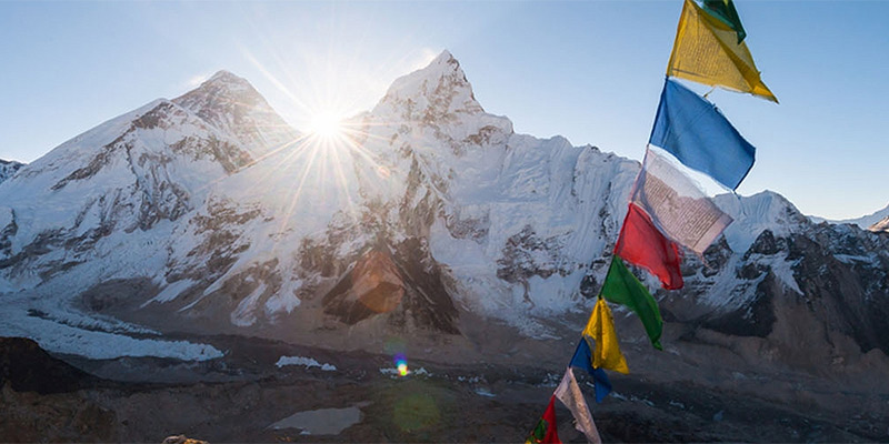 Prayer flags against a backdrop of Himalayan peaks