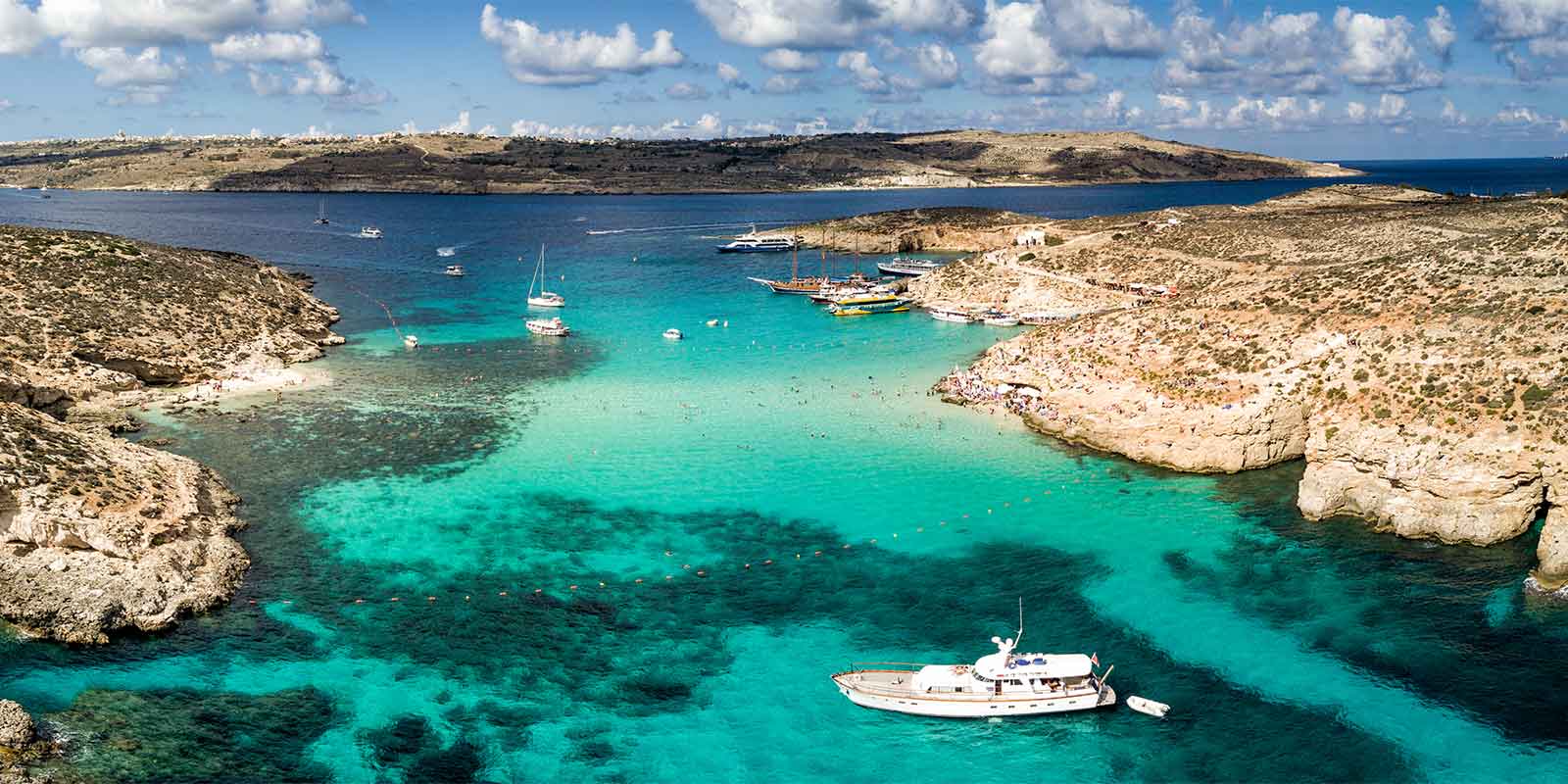 Aerial image of Blue Lagoon and boats on Comino Island Malta