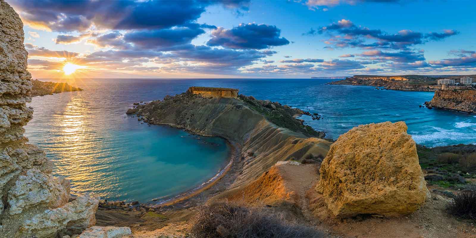View at sunset out over Gnejna Bay and Golden Bay on the island of Malta