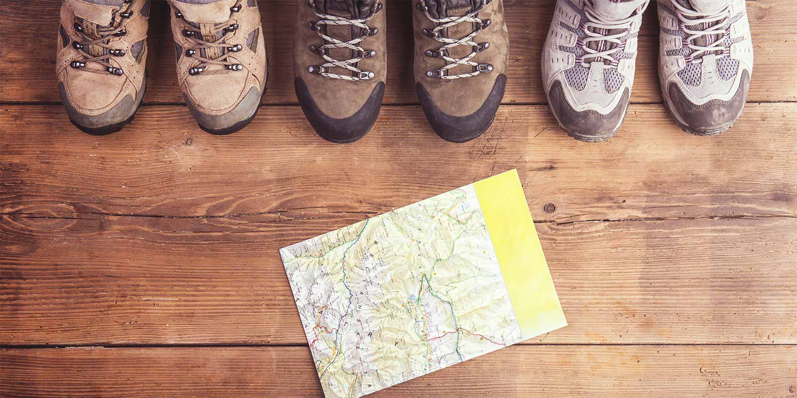 Aerial view of hiking boots and a walking map 
