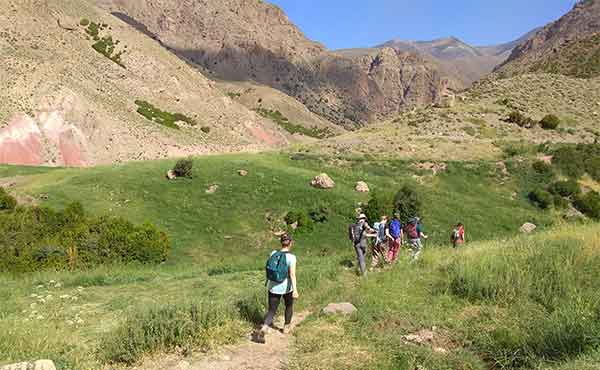 School group trekking in Ait Bouguemez Valley in Atlas Mountains of Morocco