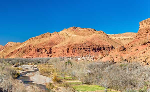 Arid landscape of Assif Mgoun Valley surrounded by rocky mountains
