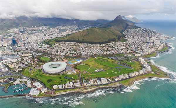 Aerial view of Cape Town with Table Mountain, stadium and rocky coastline