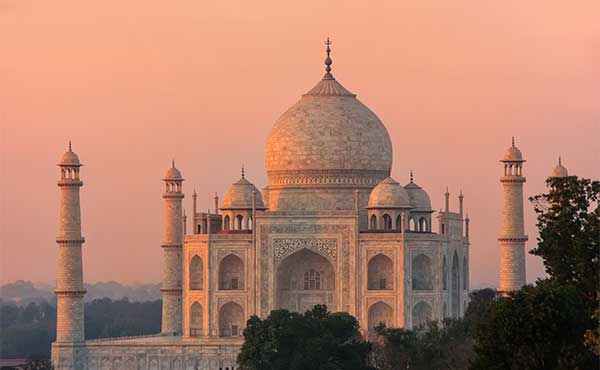 The Taj Mahal at sunset with a red hue