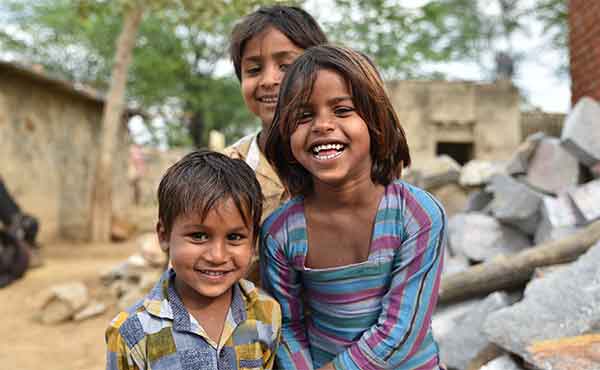 Smiling young children in a village in India
