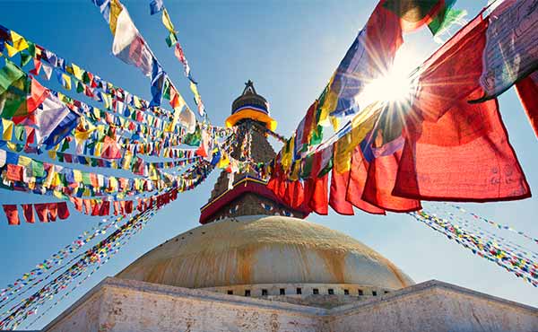 Prayer flags in the sunlight on the dome of Boudhanath Stupa