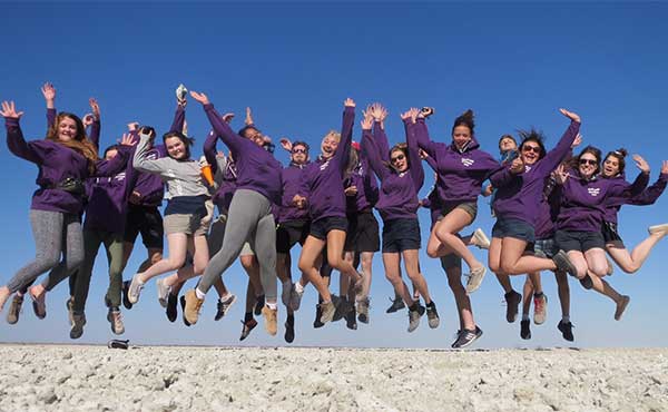 Group of students jumping in the air in Namibia