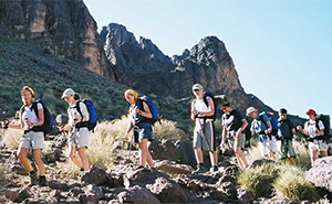 Group trekking amongst rocky mountains in Morocco