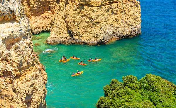 Aerial view of kayakers in turquoise sea near coast