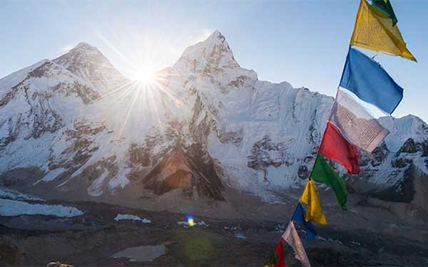 Prayer flags against a backdrop of Himalayan peaks