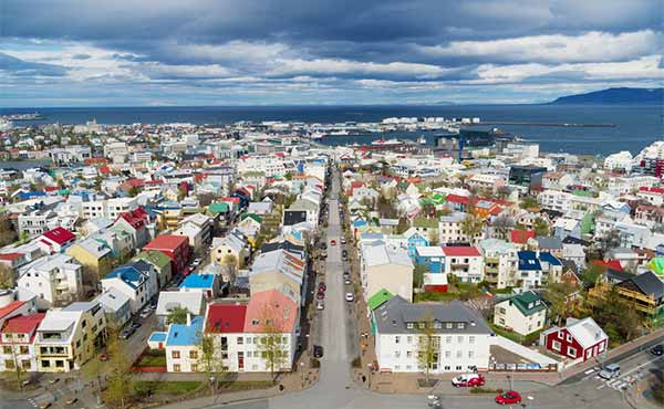 Aerial view of Reykjavik with colourful houses and harbour in the distance