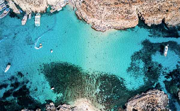 Aerial image taken by a drone of Blue Lagoon and boats on Comino Island Malta