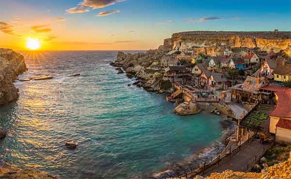 Popeye Village and Anchor Bay on the island of Malta at sunset