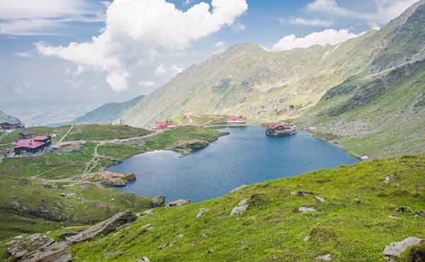 Balea Lake and cottages surrounded by Fagaras mountains