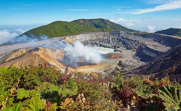 Smoking crater of Poas Volcano and surrounding vegetation