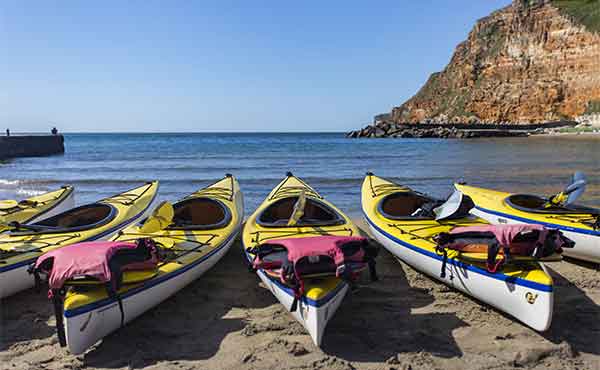 Kayaks and lifejackets waiting on the beach